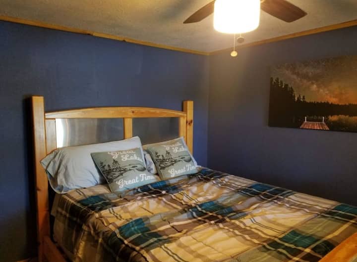 Bedroom 4: Queen bed with views of the lake.