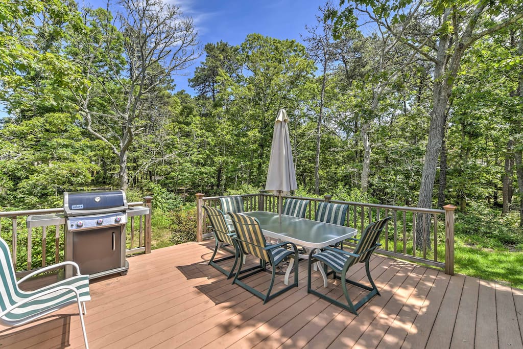 An outdoor deck with ample seating and a grill is the perfect spot for lounging in the sun.