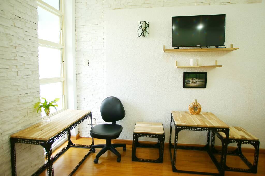 The cozy studio with full necessary amenities: nice decor closet, hangers, comfortable double bed, iron, working desk, dinning table, television, water- tea- coffee.