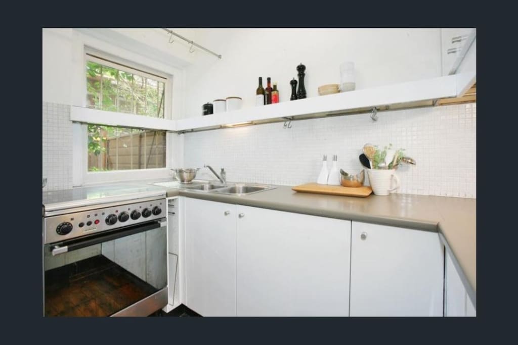 Modern kitchen with refrigerator, gas stovetop and oven and microwave