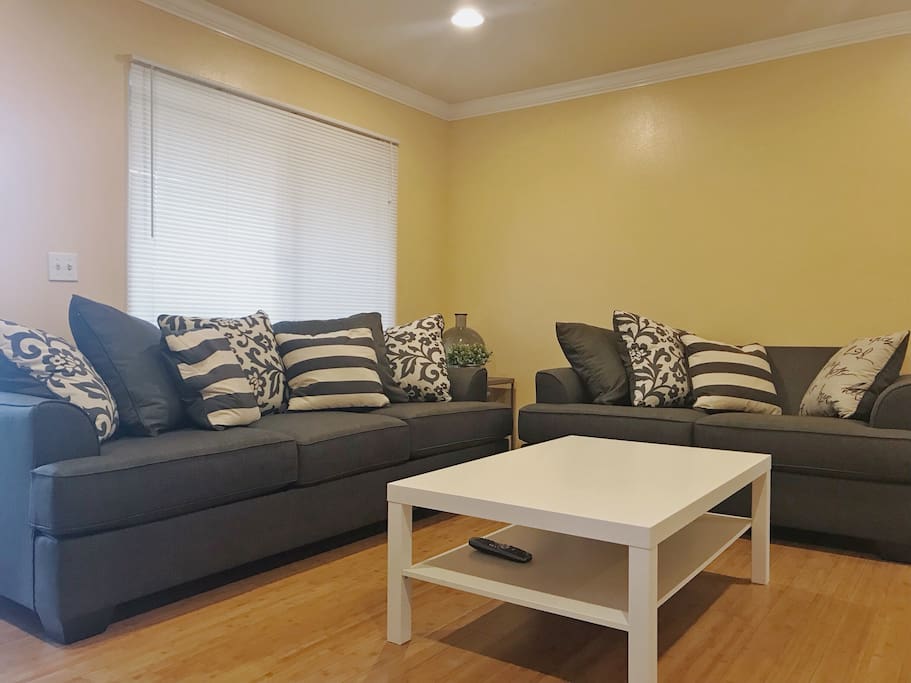 Living room with a huge TV and a pull out sofa bed with foam mattress