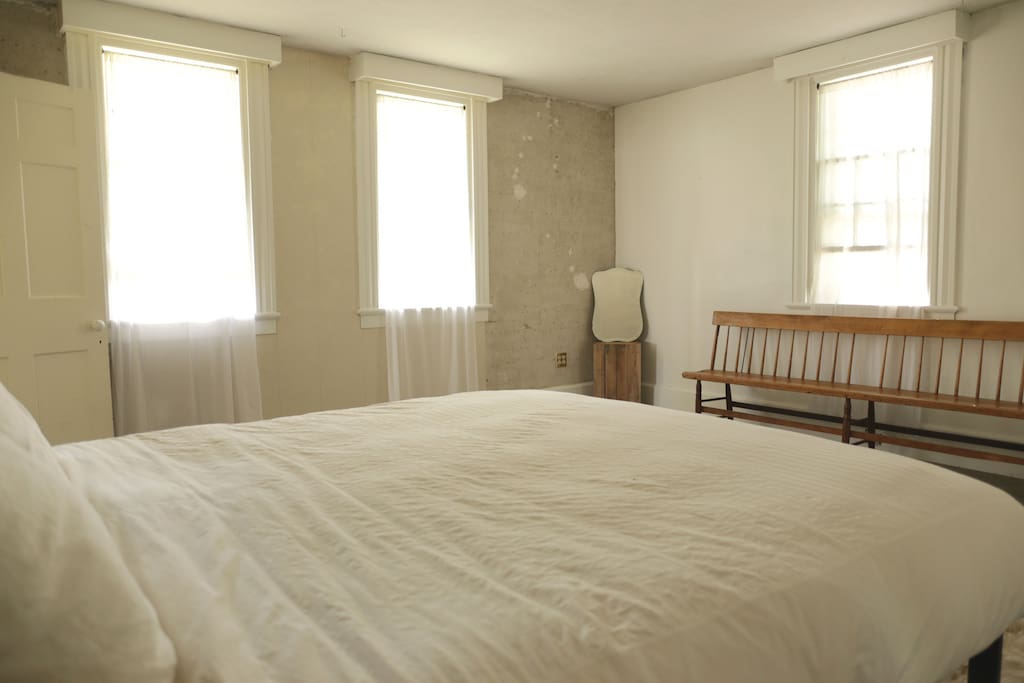 The bedroom has exposed, original horsehair plaster walls and wood floors that extend throughout the house. You'll enjoy 100% cotton and linen bedding, and a down comforter. We offer a space heater in the room during the cold months, and a window fan in the summer.