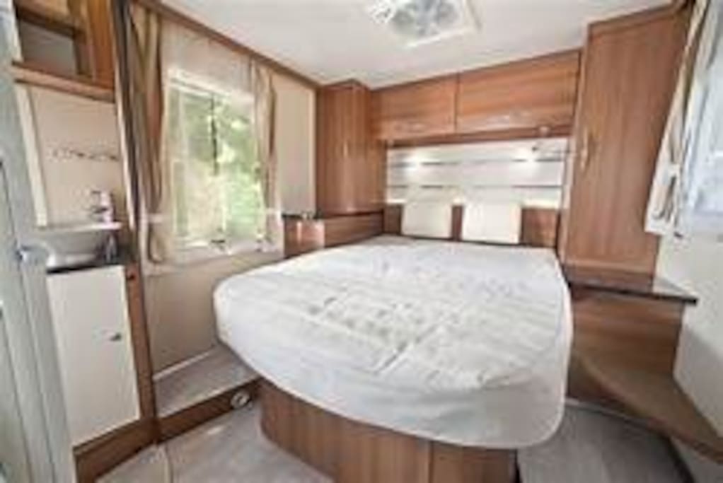 Island double bed - sliding door for privacy (curtains are blue not beige)