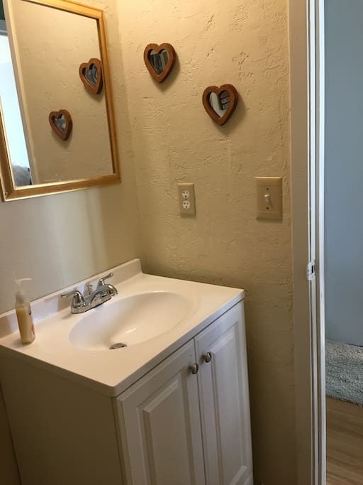 Vanity with toiletries in a small clean bathroom