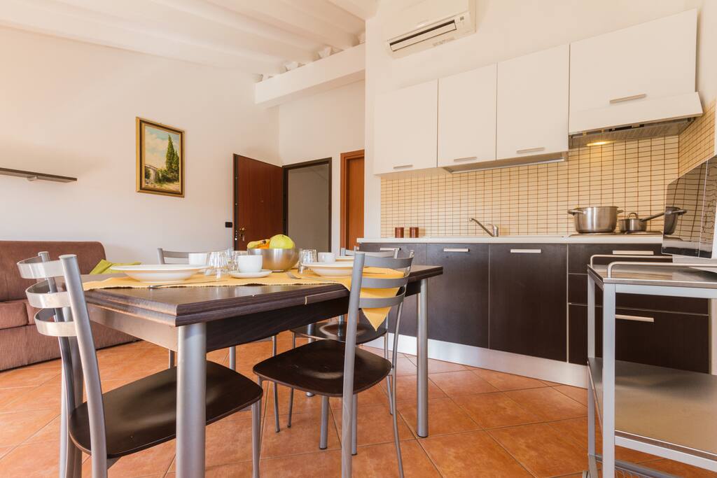 Kitchen and living room with flat screen TV dining table and sofa