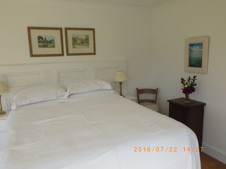 A large double bed with family paintings