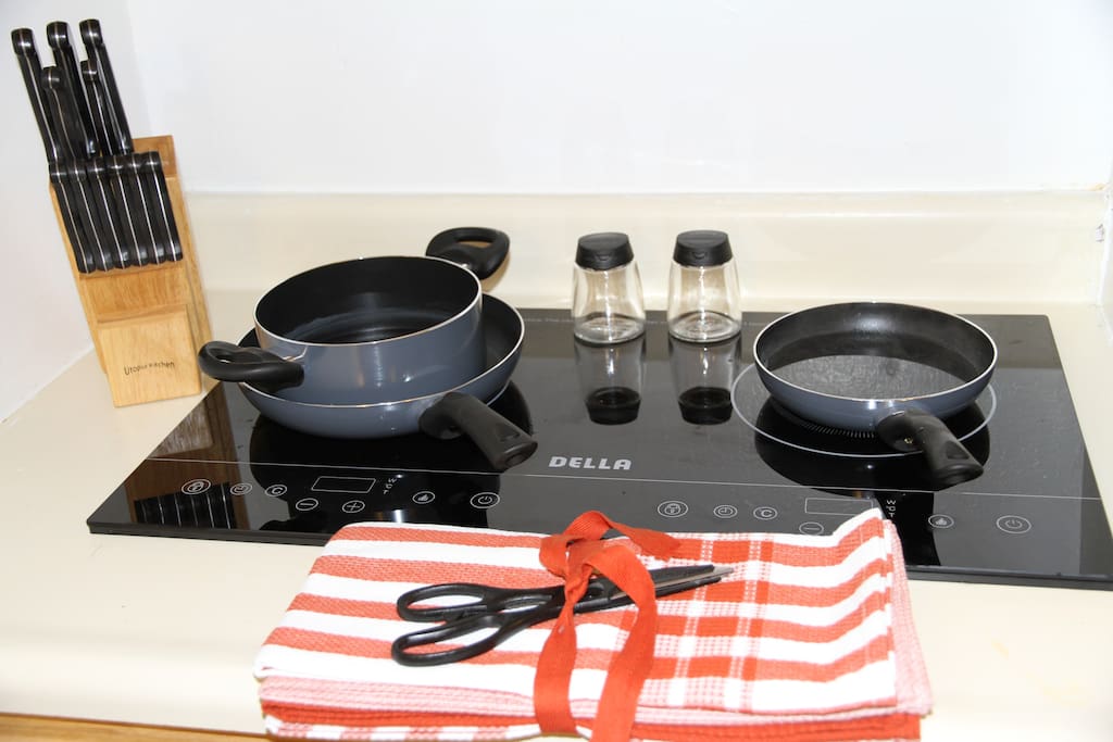 Modern Induction stove with cutting knifes, pans, etc