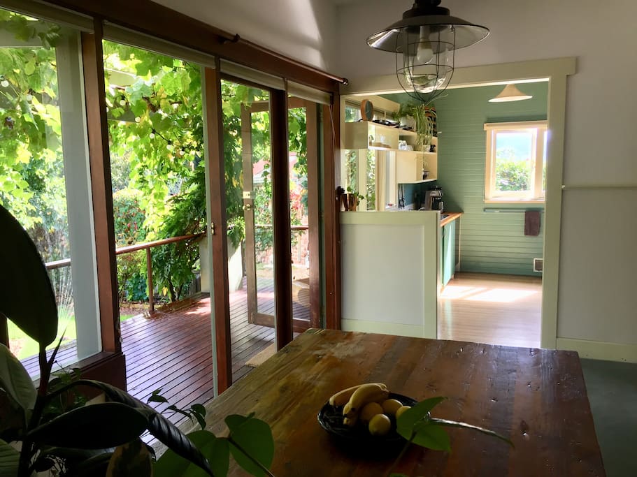 Dining table looking into the kitchen and out on to the deck