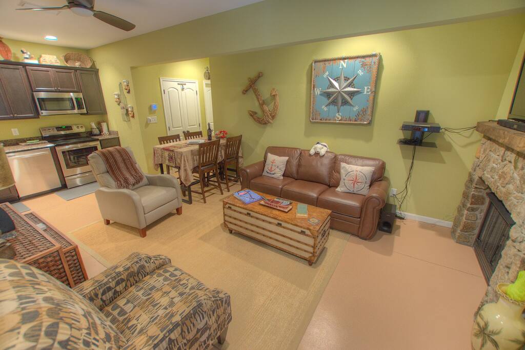 Great room with relaxing leather sofa and recliner to sit by the fireplace and watch the surround sound system