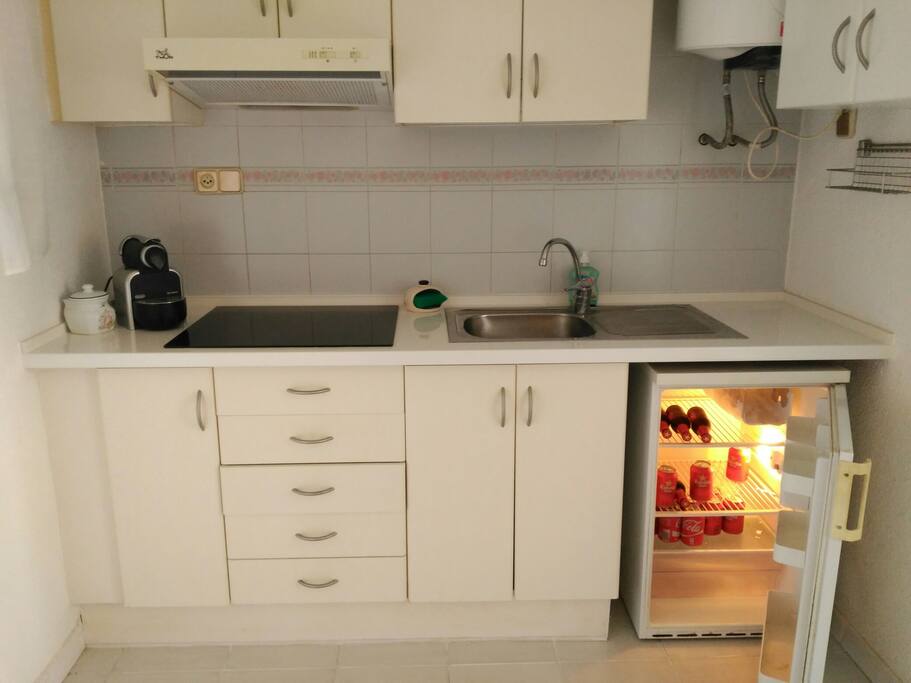 Cocina con platos, ollas y utensilios necesarios