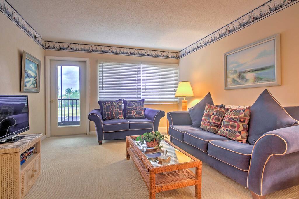 Decompress in the living room on the plush couches set in front of a flat screen cable TV.