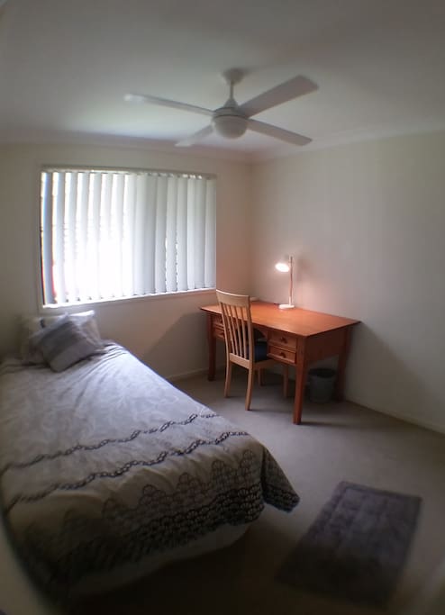 Comfortable King Single bed with a desk, chair and lamp for your convenience.
Ceiling fan and security screened window for your comfort.
