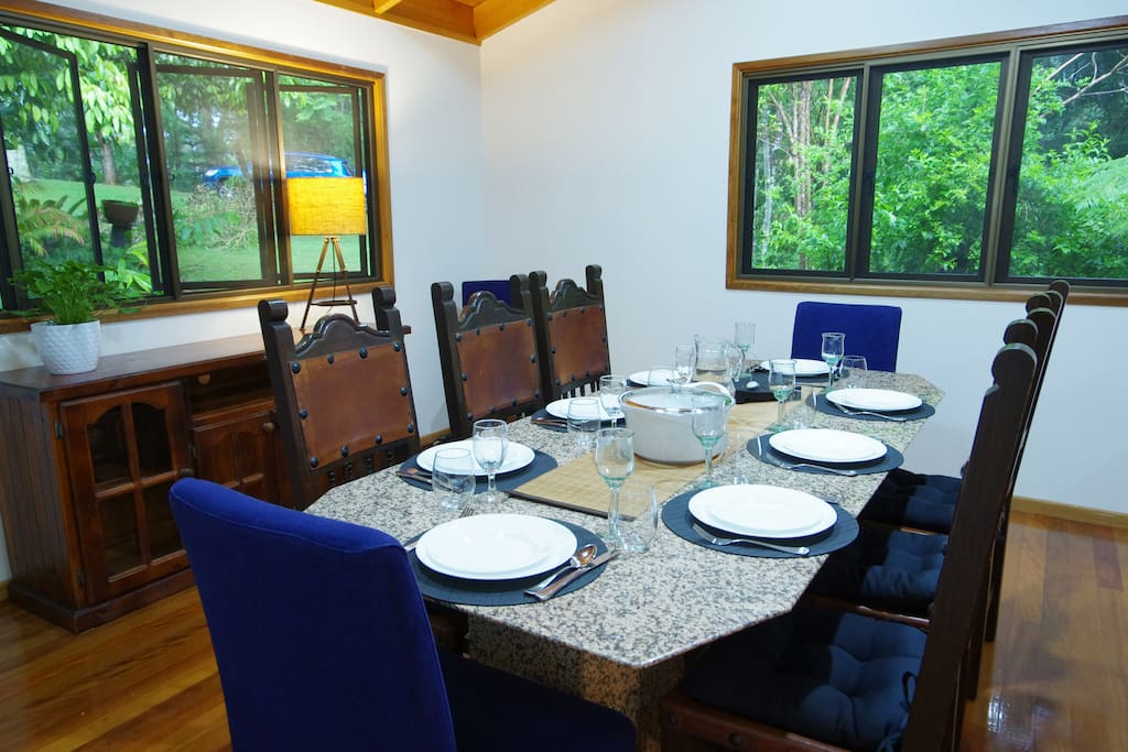 Dining area- large solid table shown set for 8 people. There are additional 2 chairs in the room corners completing seating for 10. A high chair can be found in pantry.