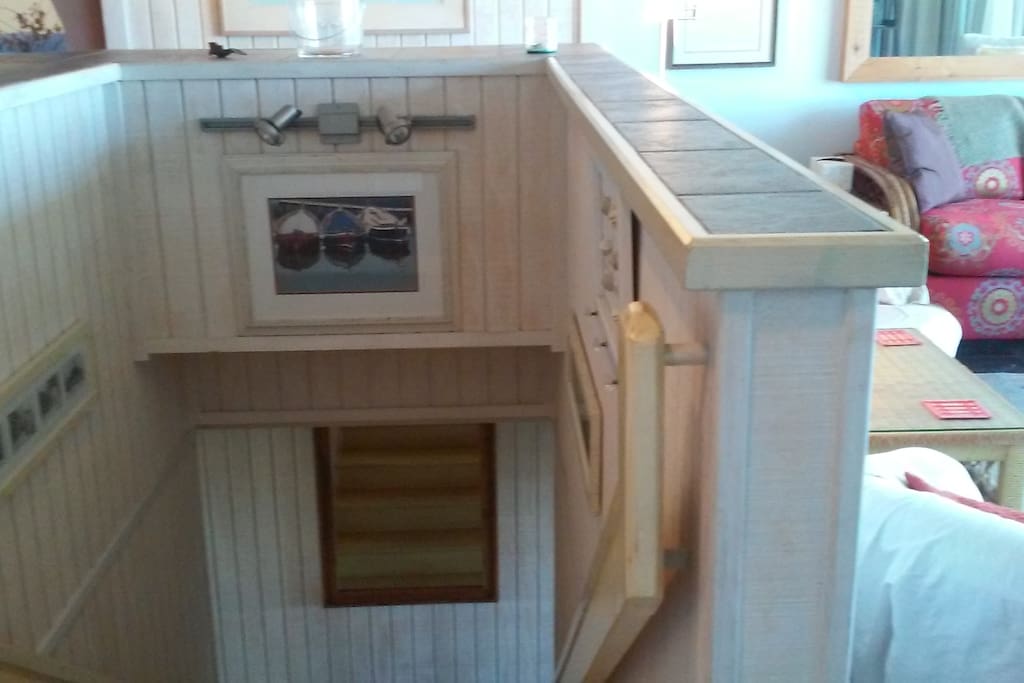 Stairway comes up in the middle of the living/dining/kitchen area. Great room style. Child gate available.