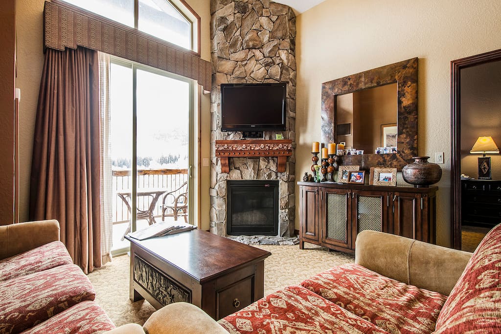 Amazing Stone covered Fireplace with wall mounted TV.