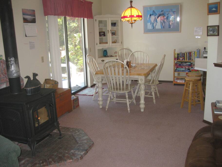 Dining area off the deck, with mountain view. You will love wood burning stove!