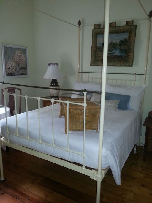 Victorian cast iron four poster double bed, set in very romantic room, looking out to attrim and garden.