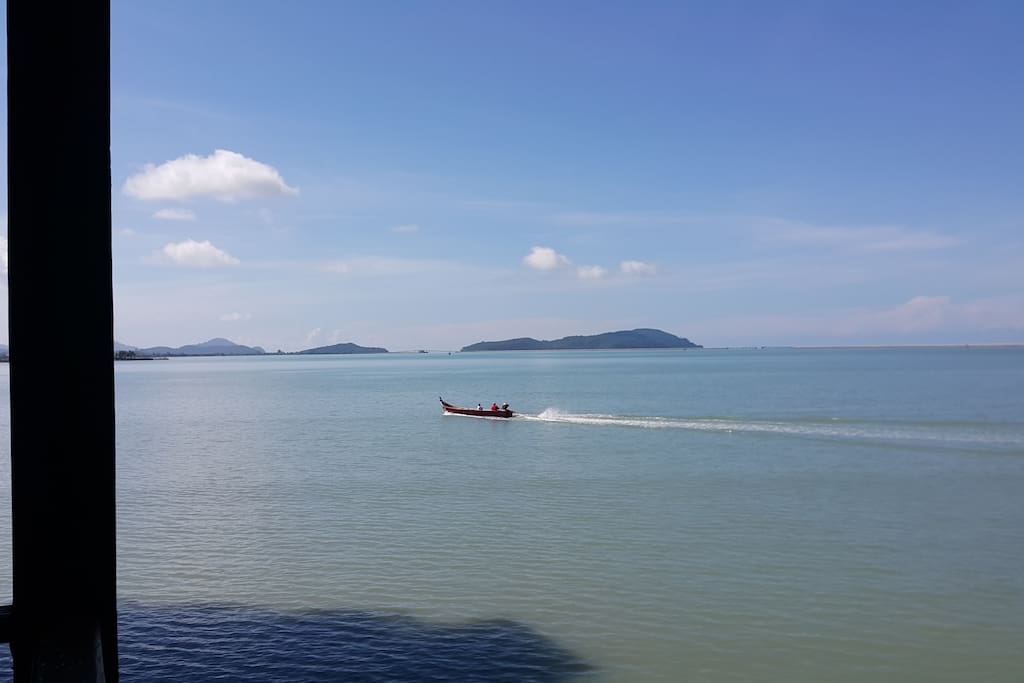Once in a while fishermen's boats pass by.