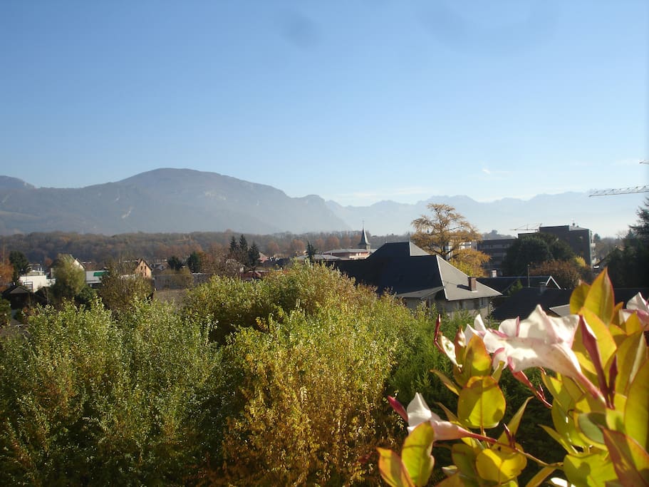 La vue depuis le balcon du salon est dégagée et donne sur les montagnes et la verdure