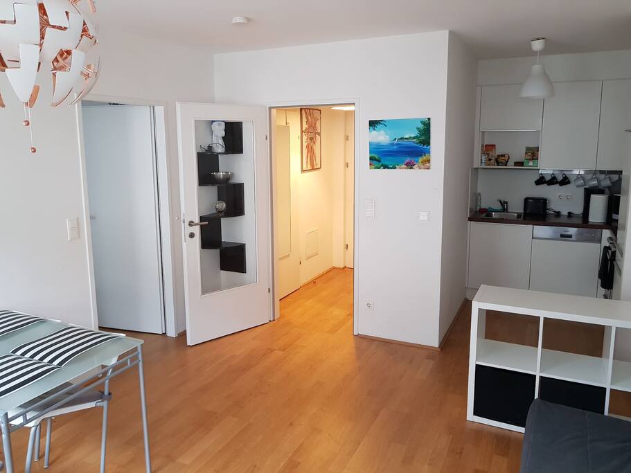 living room. to the left is the bed room, ahead the entry room, to the right kitchen
