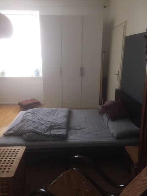 bed with free space for clothes in the wardrobe