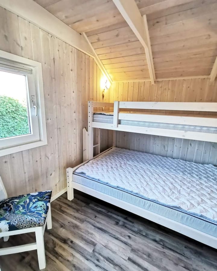 Family bunk room. 

140 x 200 cm at the bottom.
90 x 200 cm in top bunk.

Really good mattresses. 
