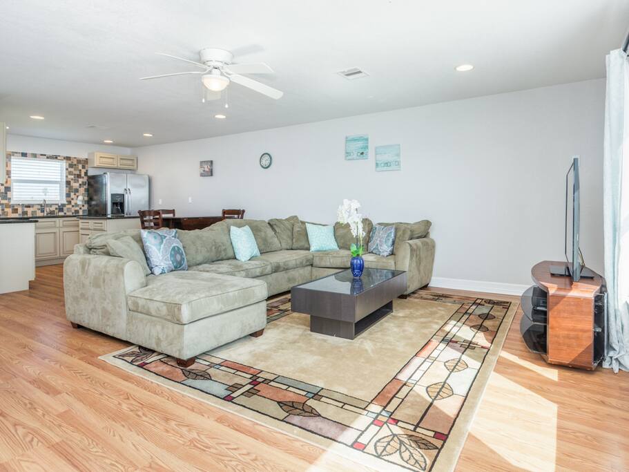 Sprawl out on a large sectional couch in an open-concept living room.