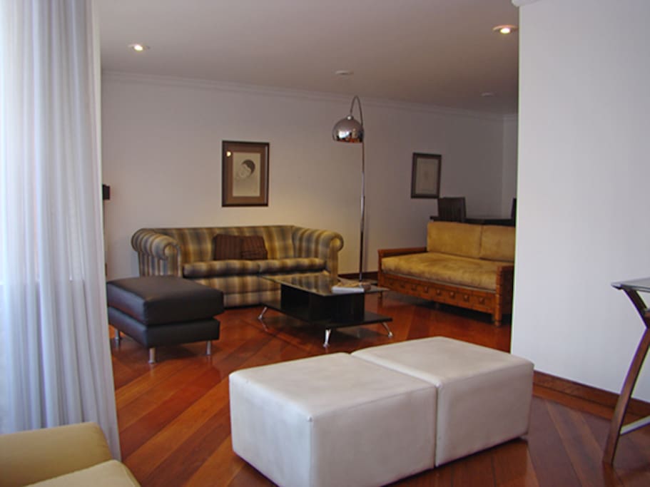 Spacious living room with fireplace and cozy couches for lounging around