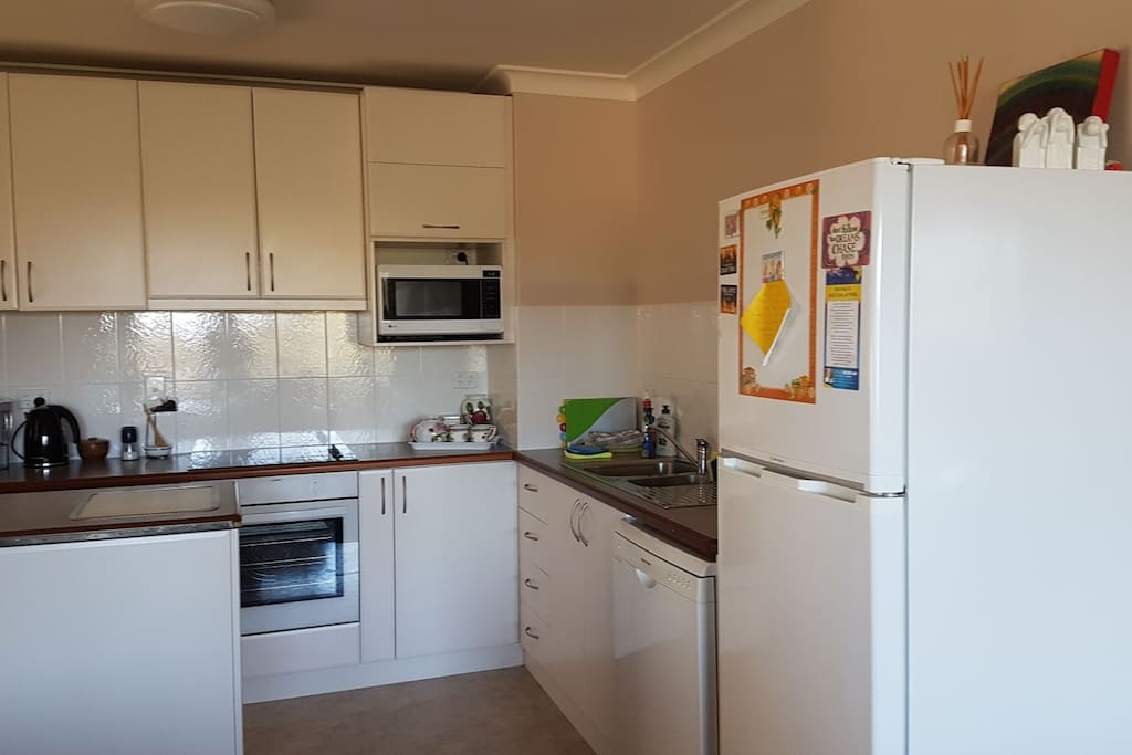Spacious kitchen.
Electric stove, oven, microwave, fridge, dishwasher. All crockery and cutlery, pots, pans. Aldi coffee maker, plus ( lots of appliances too)