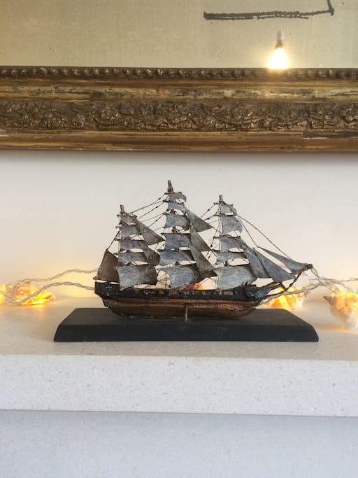 Little ship on the fireplace mantle.