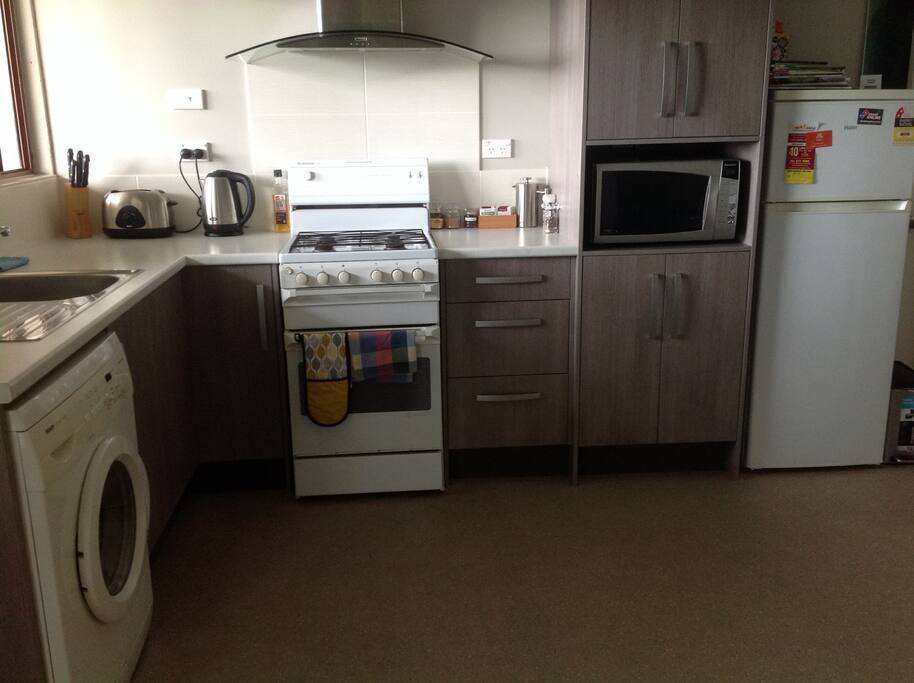 Full size kitchen with Oven, Fridge/Freezer and Washing Machine.