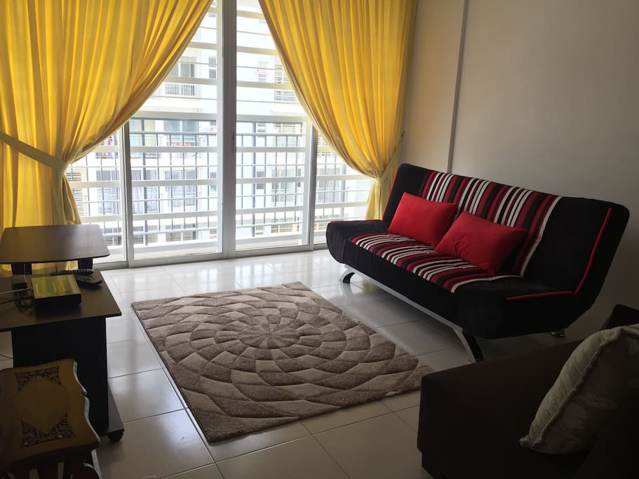 The living hall with balcony equipped with 3-seater sofa bed, 2-seater sofa and satellite TV.