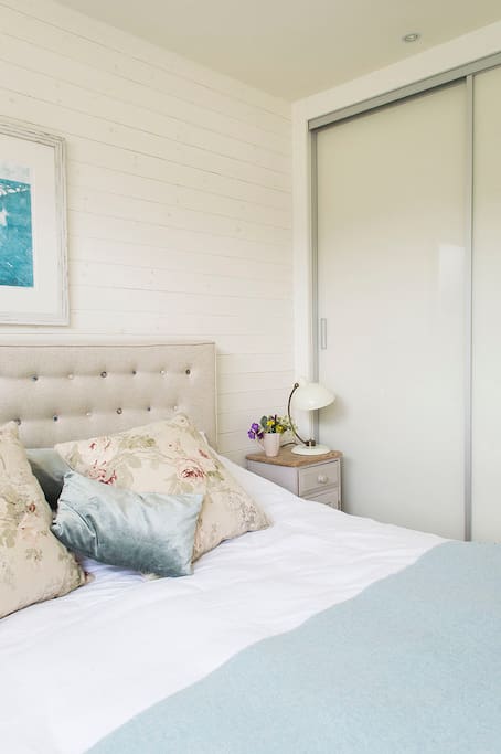 There is a built-in wardrobe in the main bedroom with hanging space and shelves.