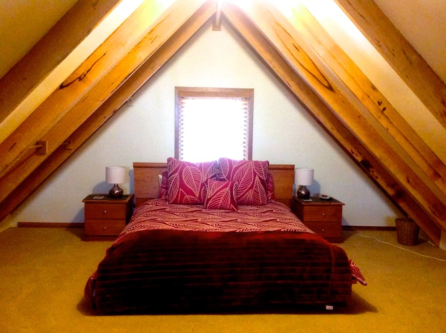 Romantic loft style bedroom with sumptuous queen bed