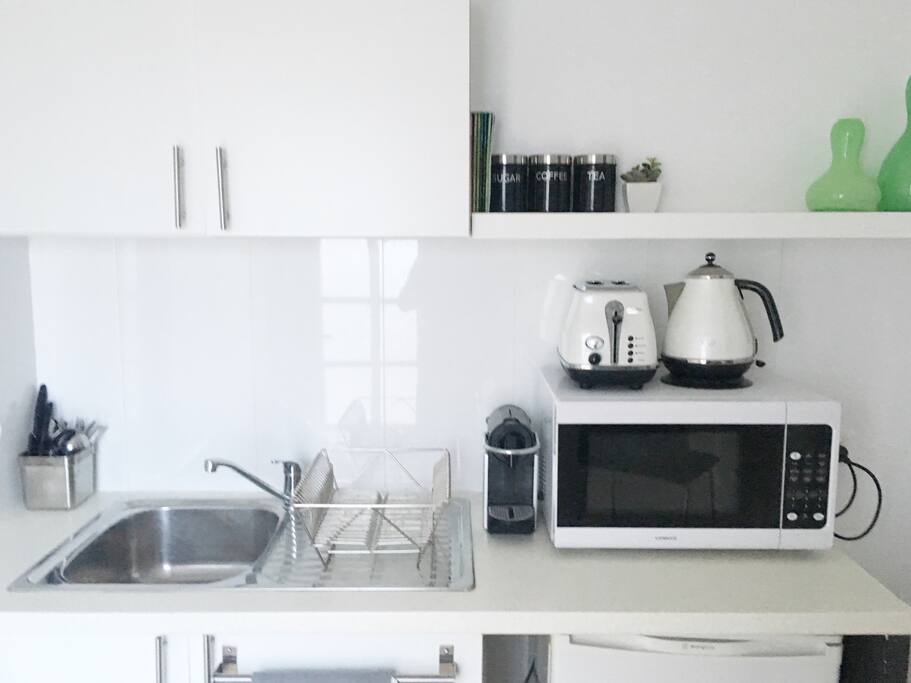 This your kitchette. It comes with a Nespresso coffee machine, Delonghi kettle and toaster, mini fridge, microwave and all the things you'll need to make a home cooked meal