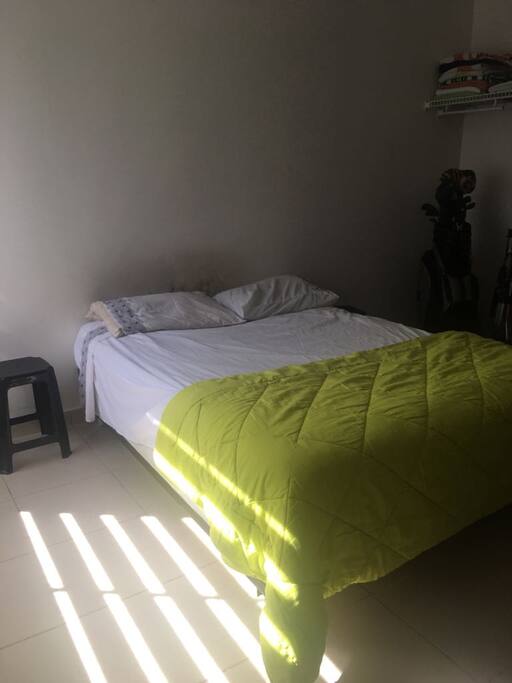 Queen size bed, with sun ligth in the afternoon