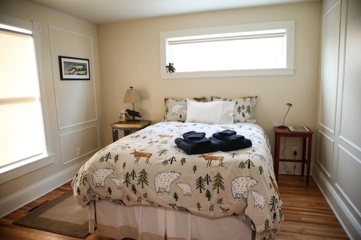 Guest bedroom perfectly appointed with a queen bed and flannel sheets during snowy winter nights.