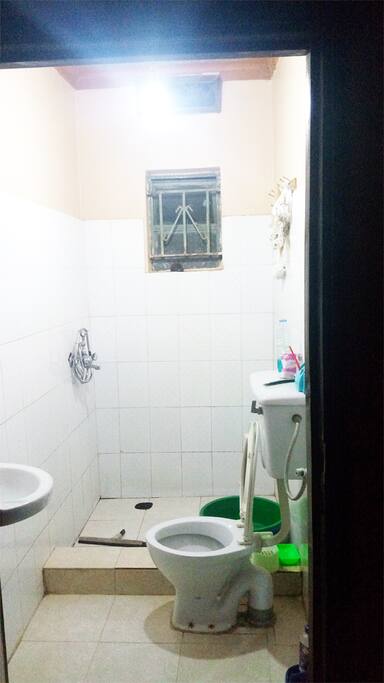 Clean tiled bathroom and flushing toilet