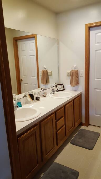 Double sink in Jack & Jill bathroom. Shower and toilet are located directly behind in a separate room.