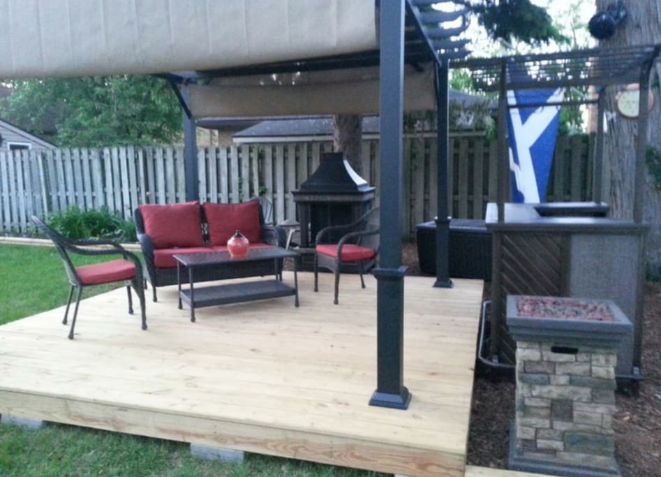 Pergola in Private / Fenced Backyard with Tiki Bar, Fireplace, Fire Column, DJ Speaker / AMP System, Plug in Connection for your Phone / Electronic Device.