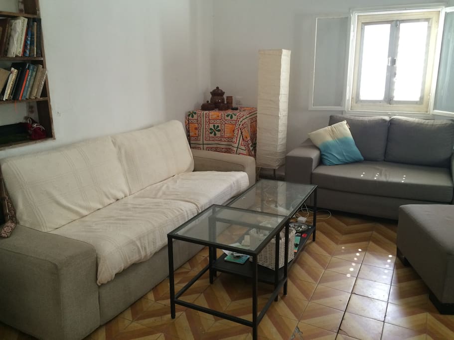 The large white sofa is big enough for a person to sleep on if needed