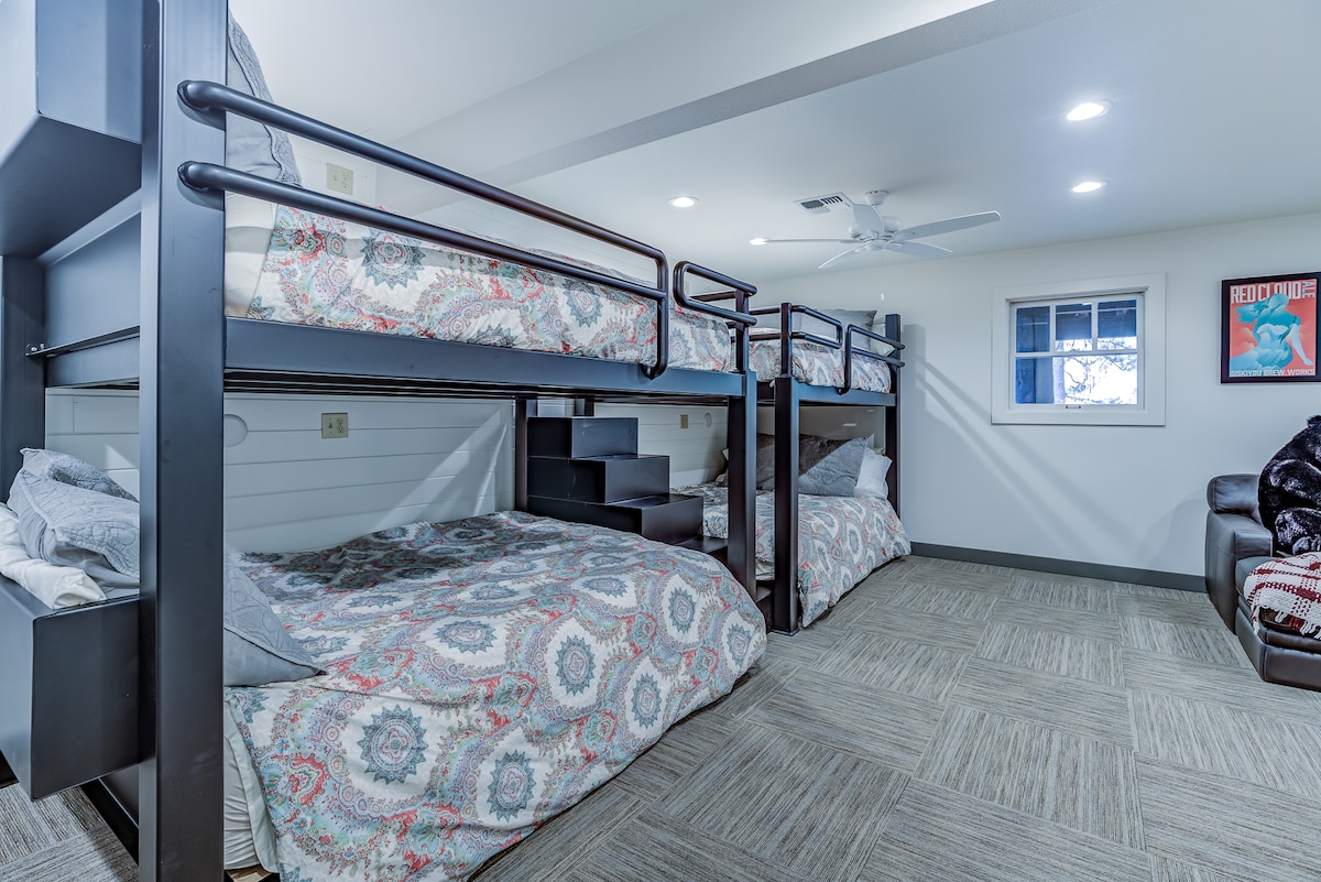 The basement bedroom offers custom bunk beds containing 4 queen beds. 