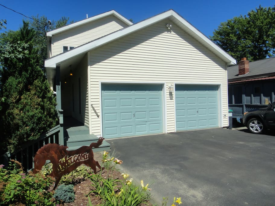 The house faces the lake, off-street parking is in front of the garage.