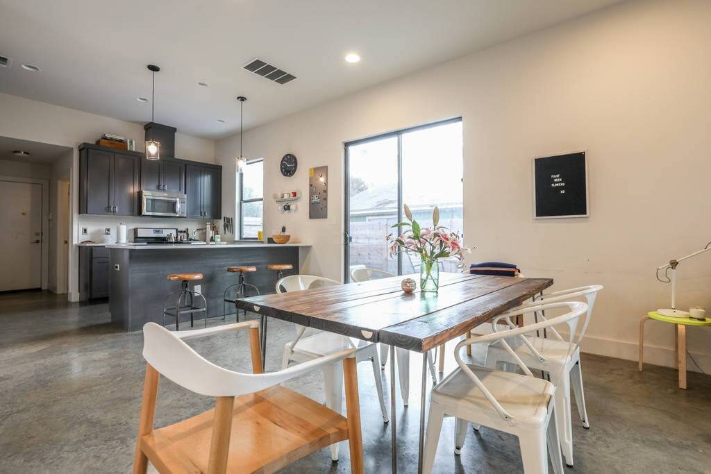 Open floor plan dining room with a handmade table that seats 6 or more