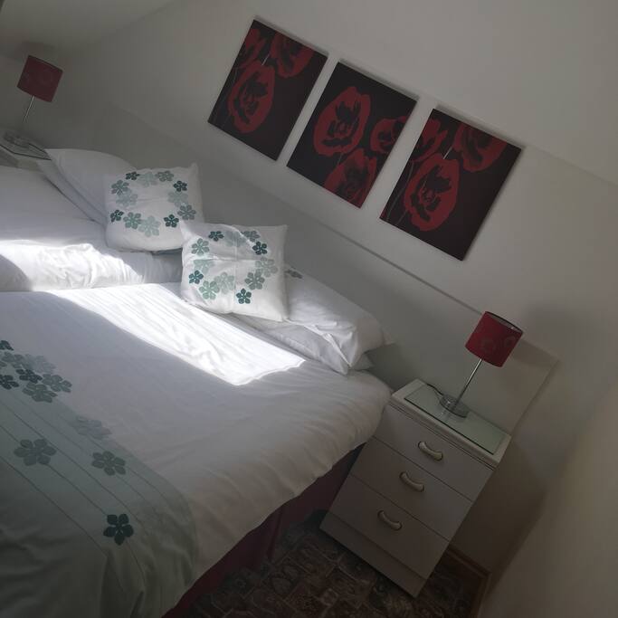 Separate bedroom with twin beds. Wardrobe, bedside cabinets and tv.