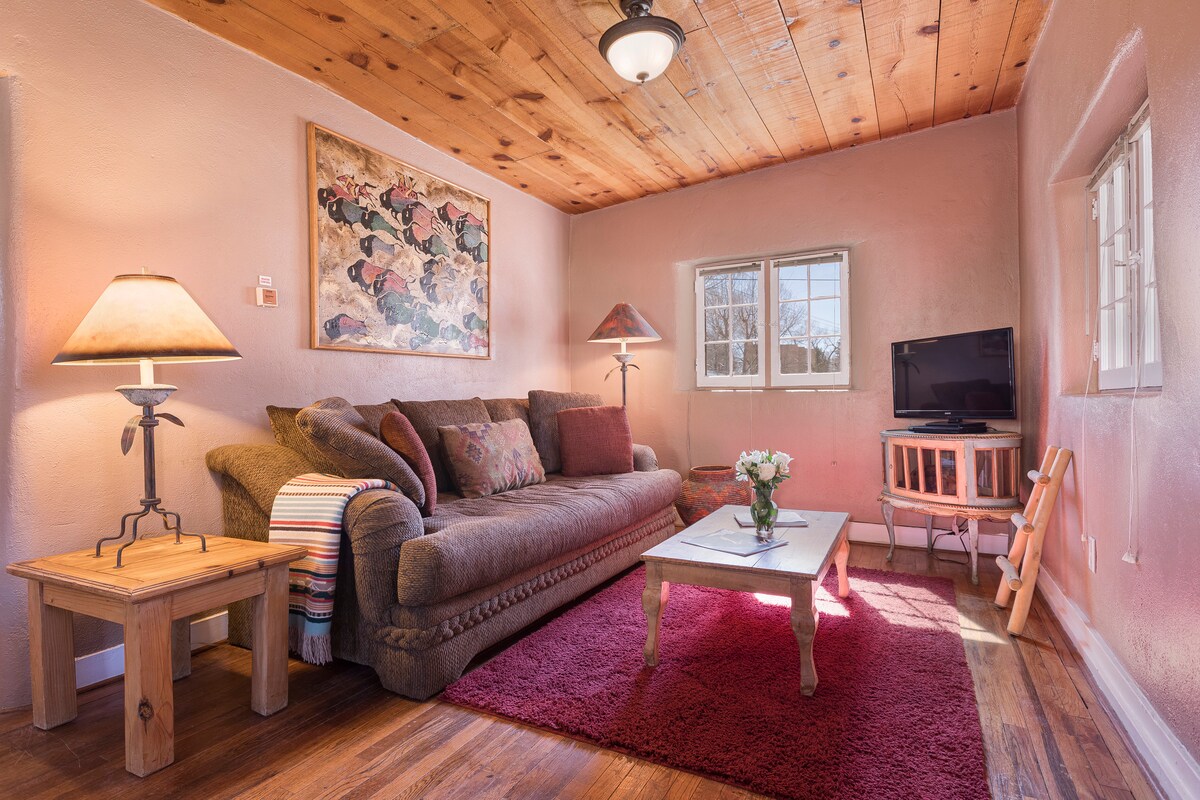 The living room - a spacious sunny couch, the flat screen TV