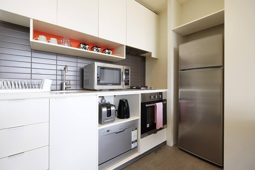 Kitchen with basic cooking utensils and appliances.
