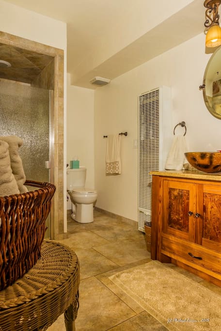 Modern bathroom is spacious, featuring a nice, clean tiled shower.