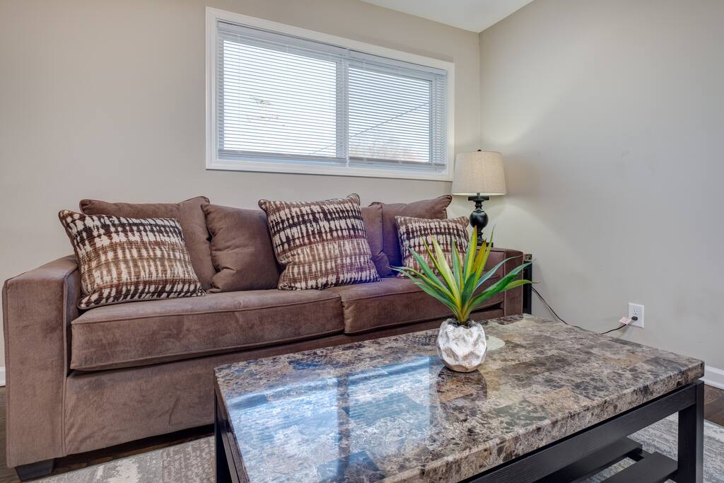 Relax in Unit 1's cozy living space featuring a queen-size sleeper sofa and a 42" flat screen TV.
