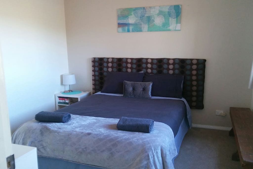 Private bedroom with Queen size bed, linen, towels, ceiling fan, heater and shelves to store your items.
(extra linen and pillows if required in cupboard)
